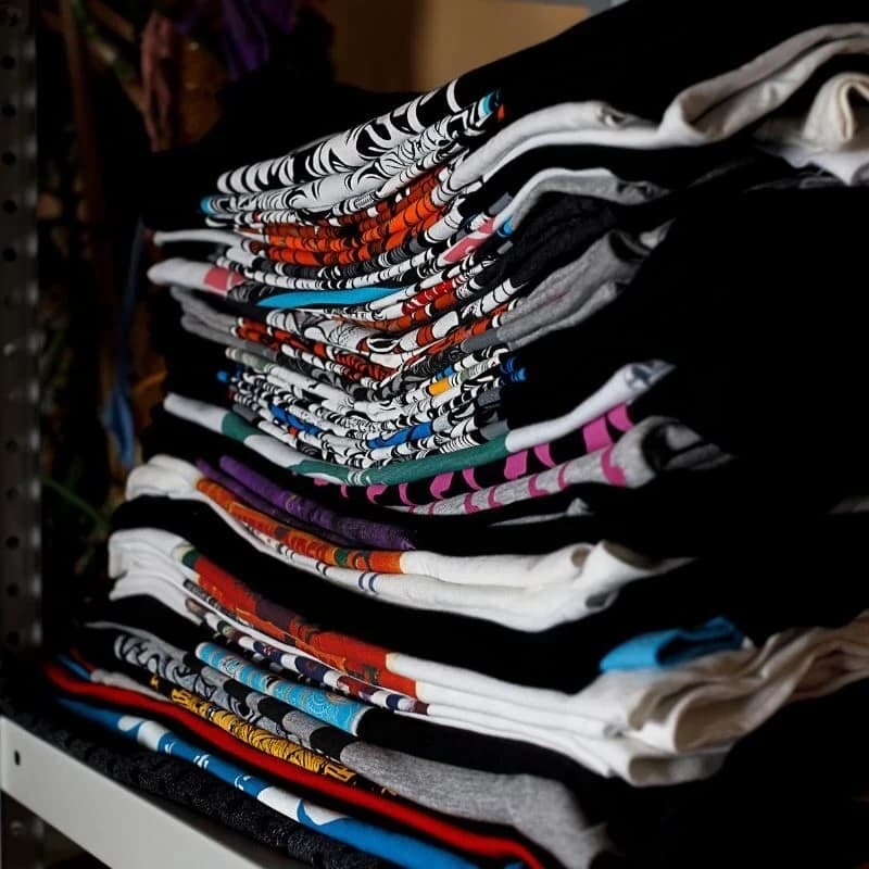 Stack of custom screen-printed t-shirts by Printology